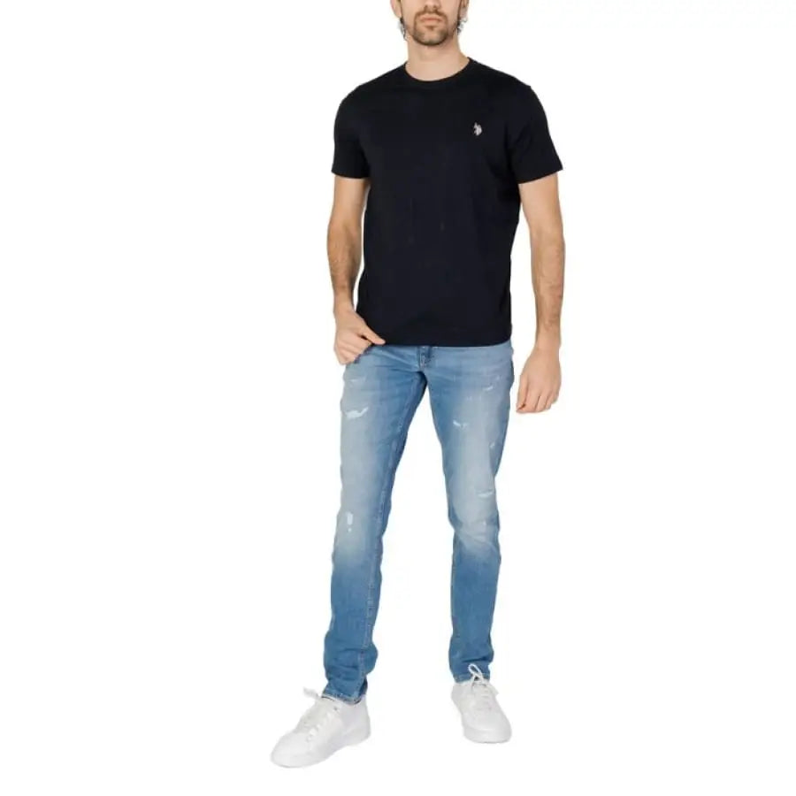 Man in U.S. Polo Assn. men t-shirt and jeans, showcasing apparel accessories.