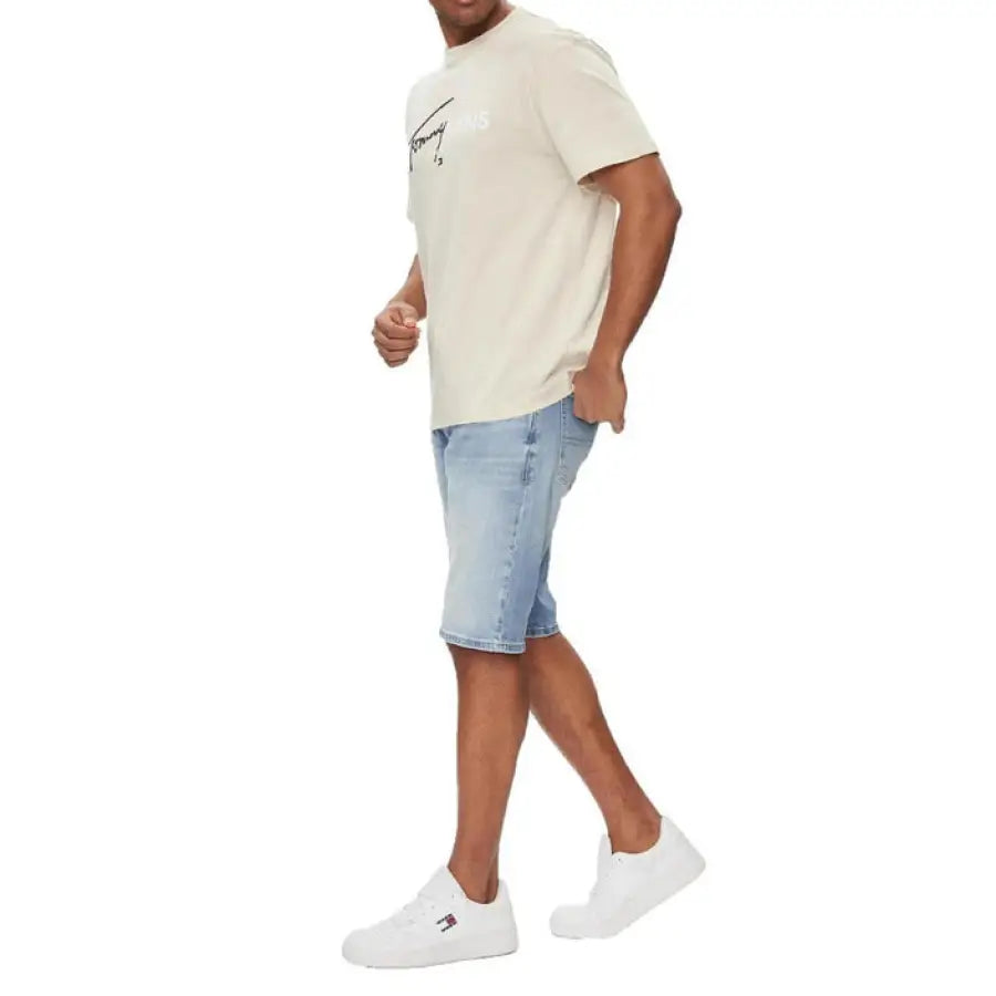 Man in Tommy Hilfiger Jeans wearing white t-shirt and blue shorts