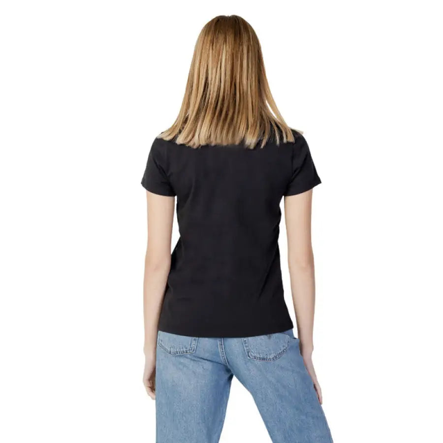 Woman in Levi’s women t-shirt and jeans showcasing urban style clothing