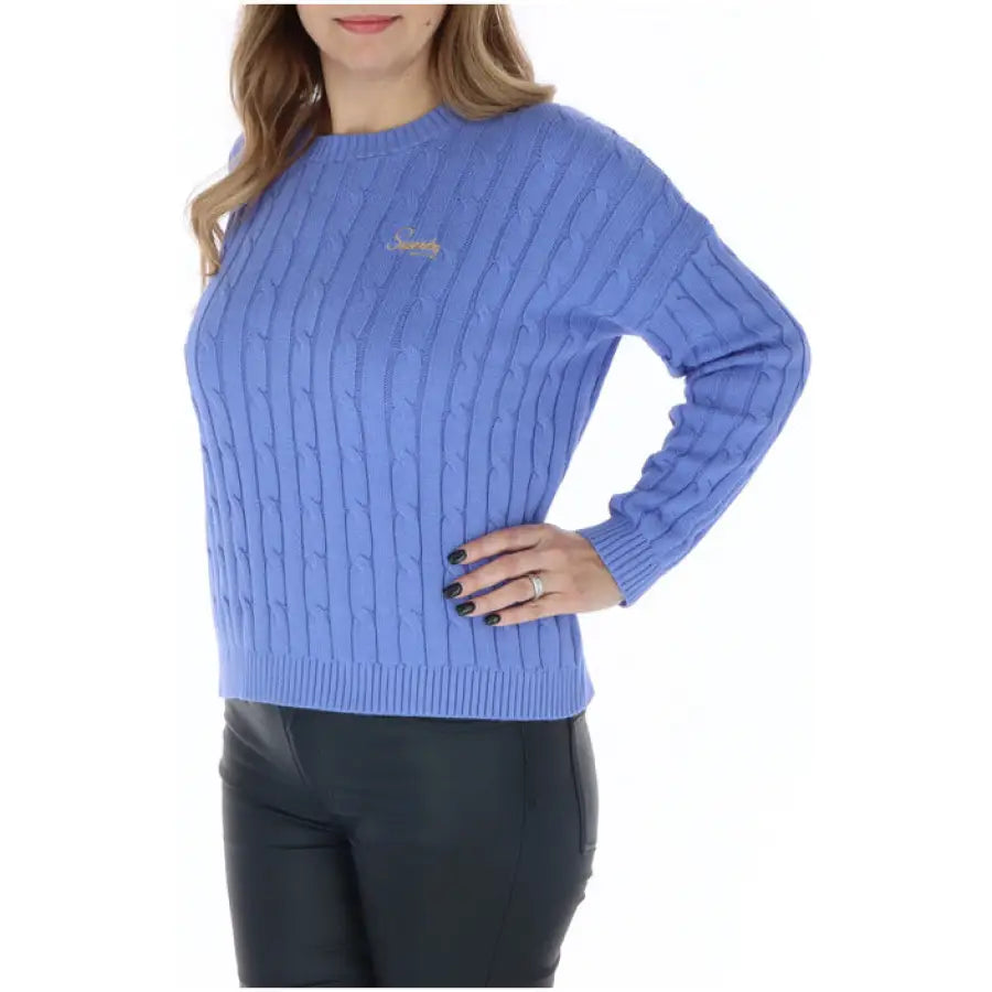 Woman in Superdry women knitwear, blue cable knit sweater featured
